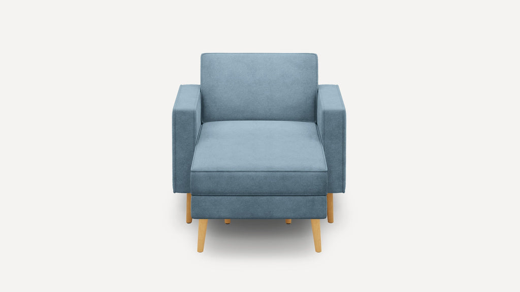 Front view of a modern blue upholstered armchair with wooden legs on a white background.