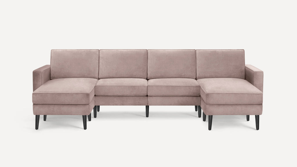 Modern mauve velvet sectional sofa with black tapered wooden legs, featuring left and right chaise lounge ends.