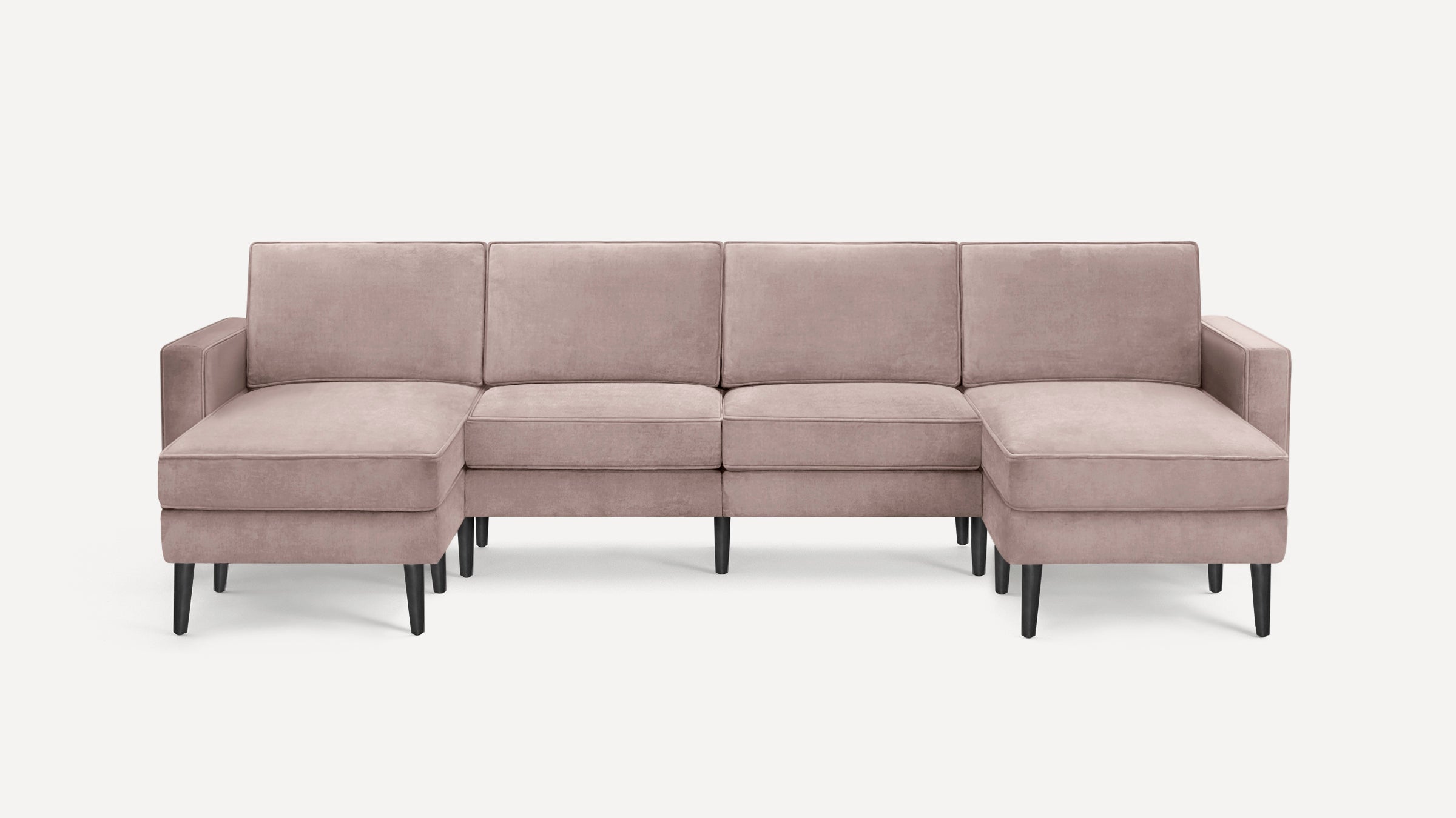 Modern mauve velvet sectional sofa with black tapered wooden legs, featuring left and right chaise lounge ends.