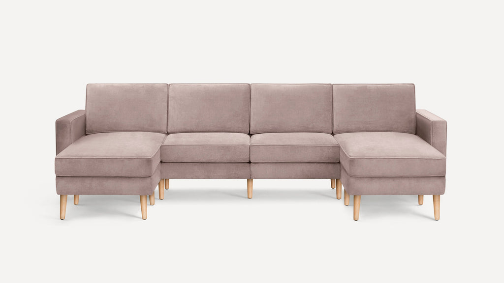Modern L-shaped sectional sofa in soft beige fabric with wooden legs, featuring left and right chaise lounges.