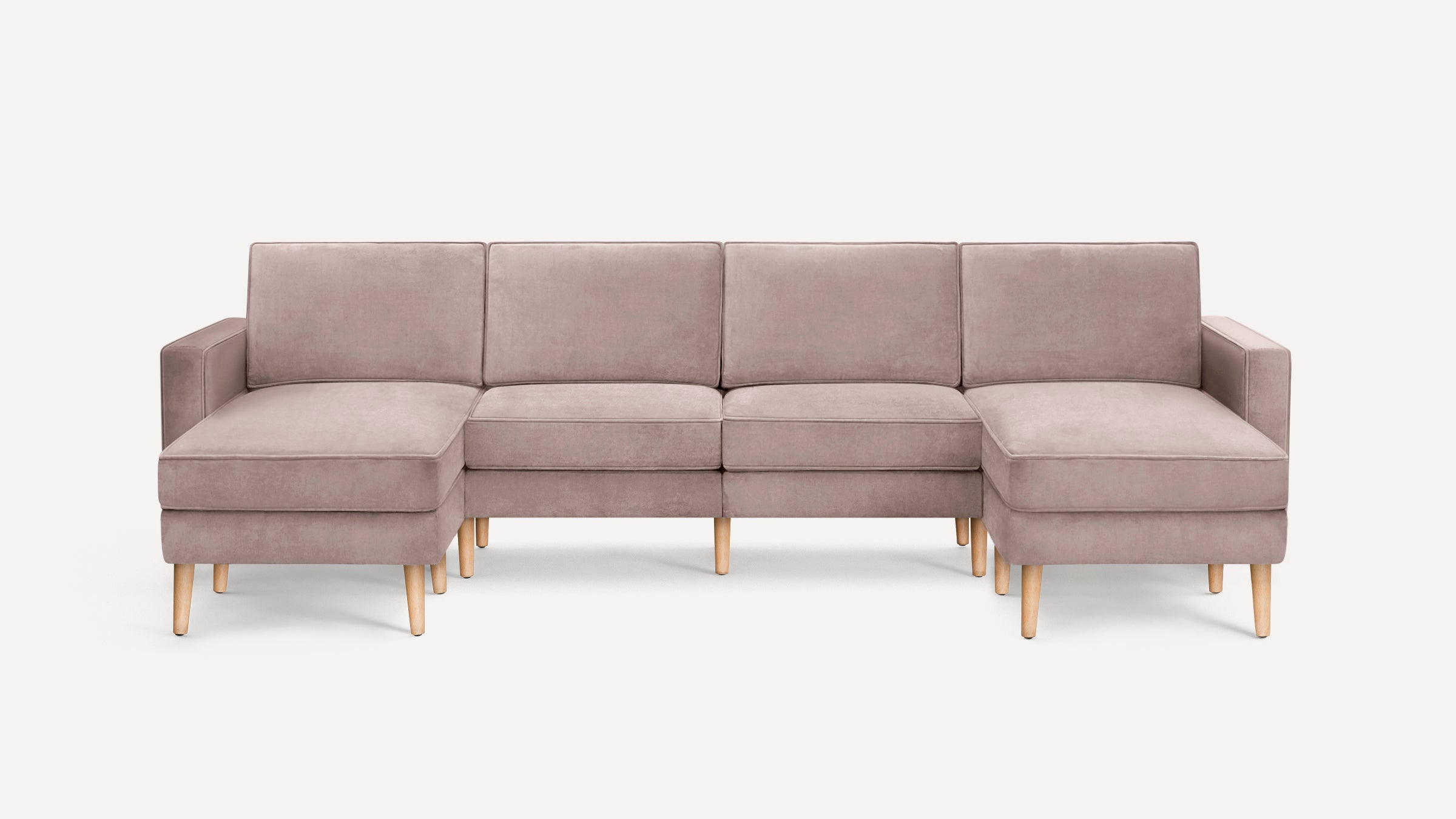 Modern L-shaped sectional sofa in soft beige fabric with wooden legs, featuring left and right chaise lounges.