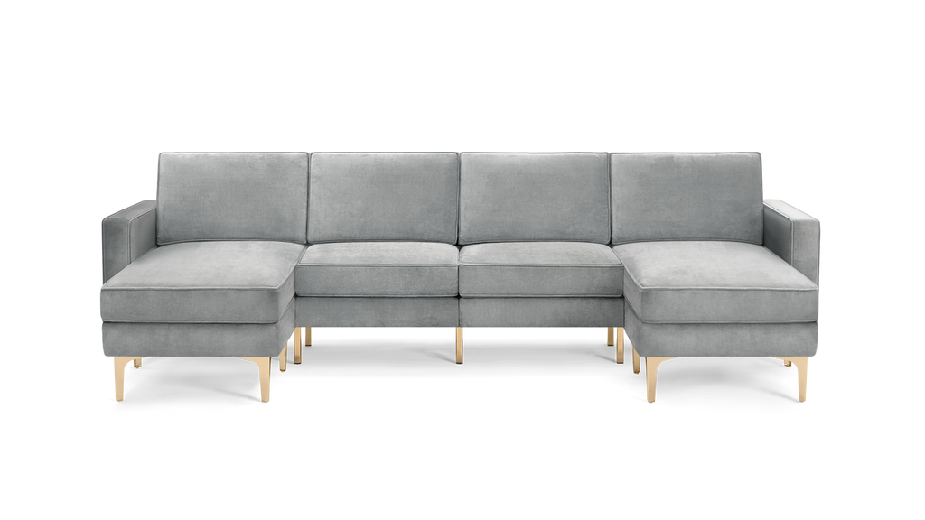 modern light gray velvet sectional sofa with gold metal legs and clean lines on the back, featuring a chaise lounge and matching ottoman