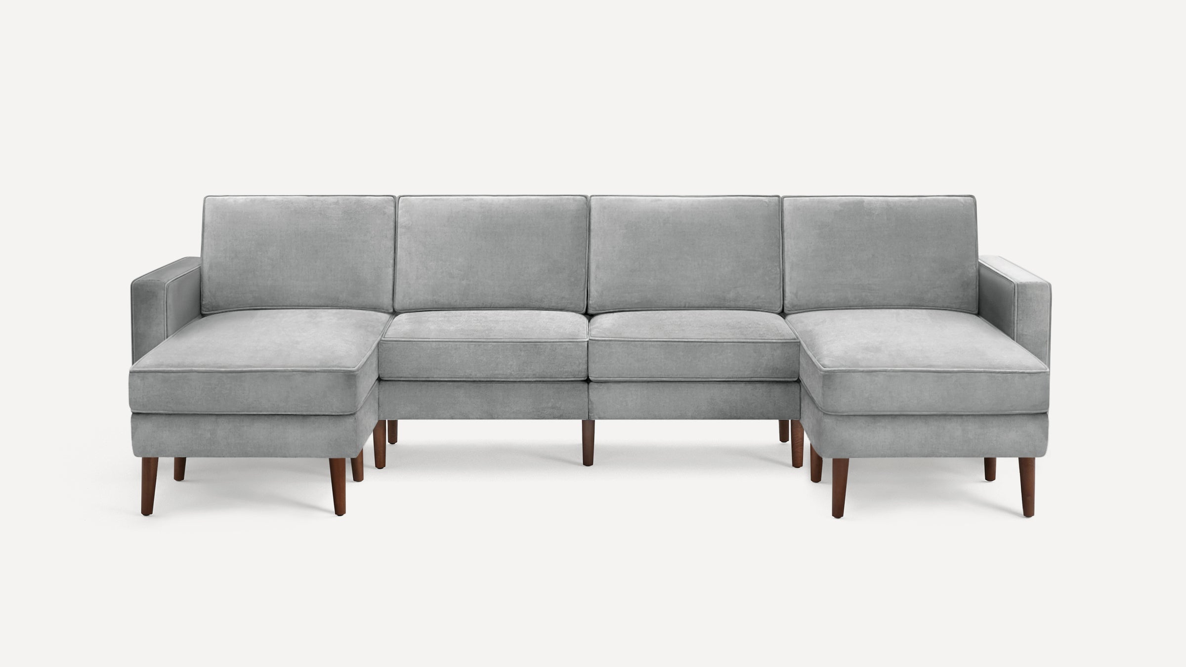 Modern light gray velvet sectional sofa with wooden legs, featuring two chaise lounges on each end and three seat cushions.