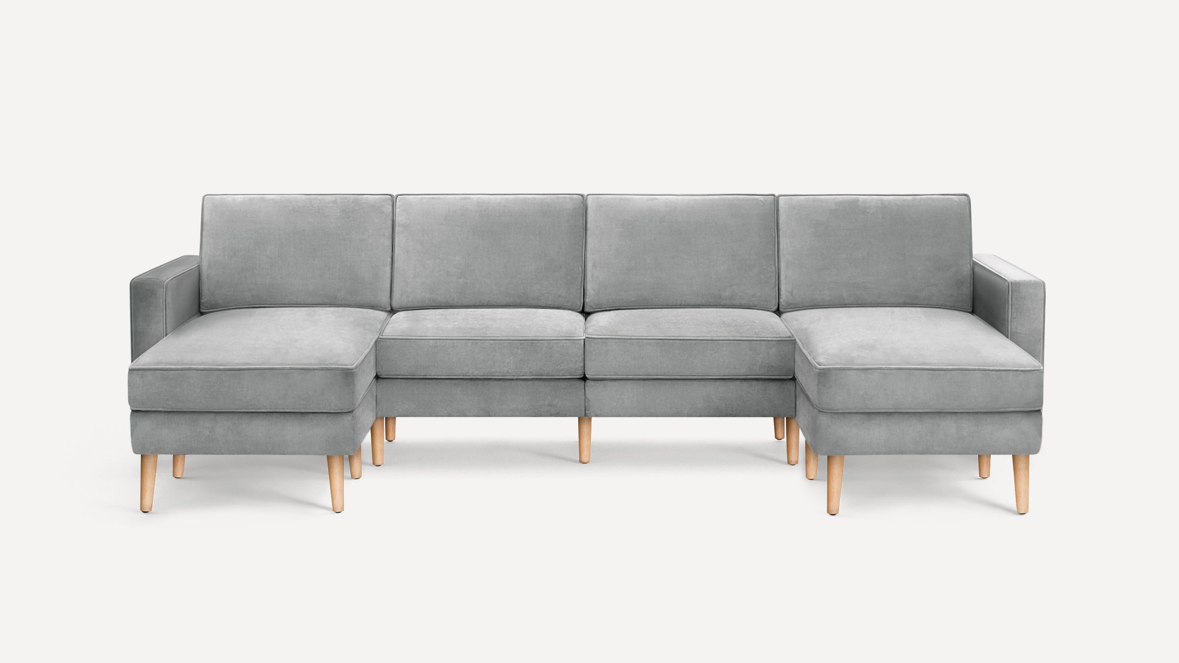 Modern gray sectional sofa with wooden legs, featuring two chaise lounges on either end and clean, simple lines.