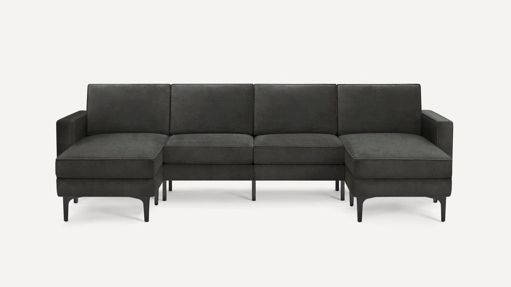 Dark gray modern sectional sofa with left and right chaise lounges, slim black legs, and clean lines, on a white background.