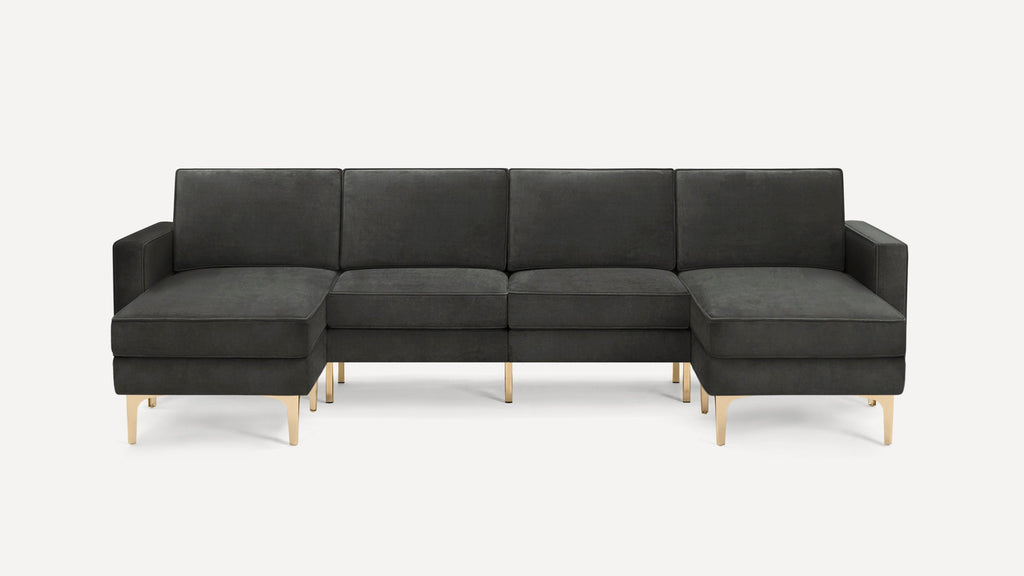 Dark gray velvet U-shaped sectional sofa with gold metal legs and clean modern design on white background.