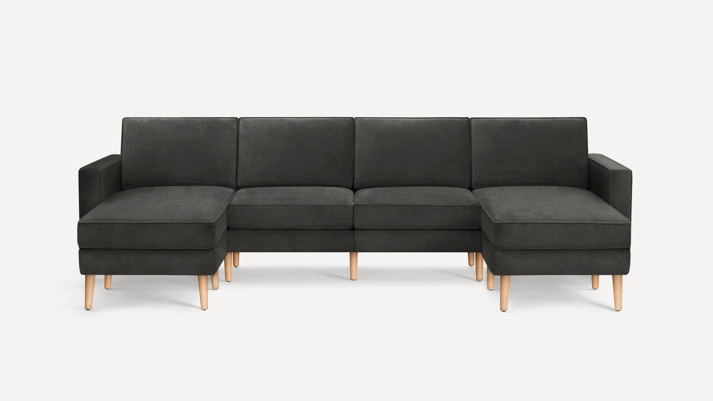 Modern dark gray fabric sectional sofa with wooden legs and chaise lounge on both ends, set against a plain white background.