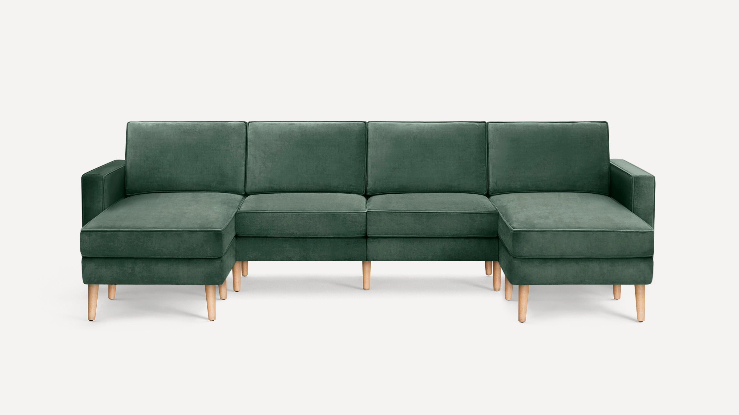 Modern green velvet sectional sofa with wooden legs, featuring two chaise lounges on each side and three cushioned seats in the center.