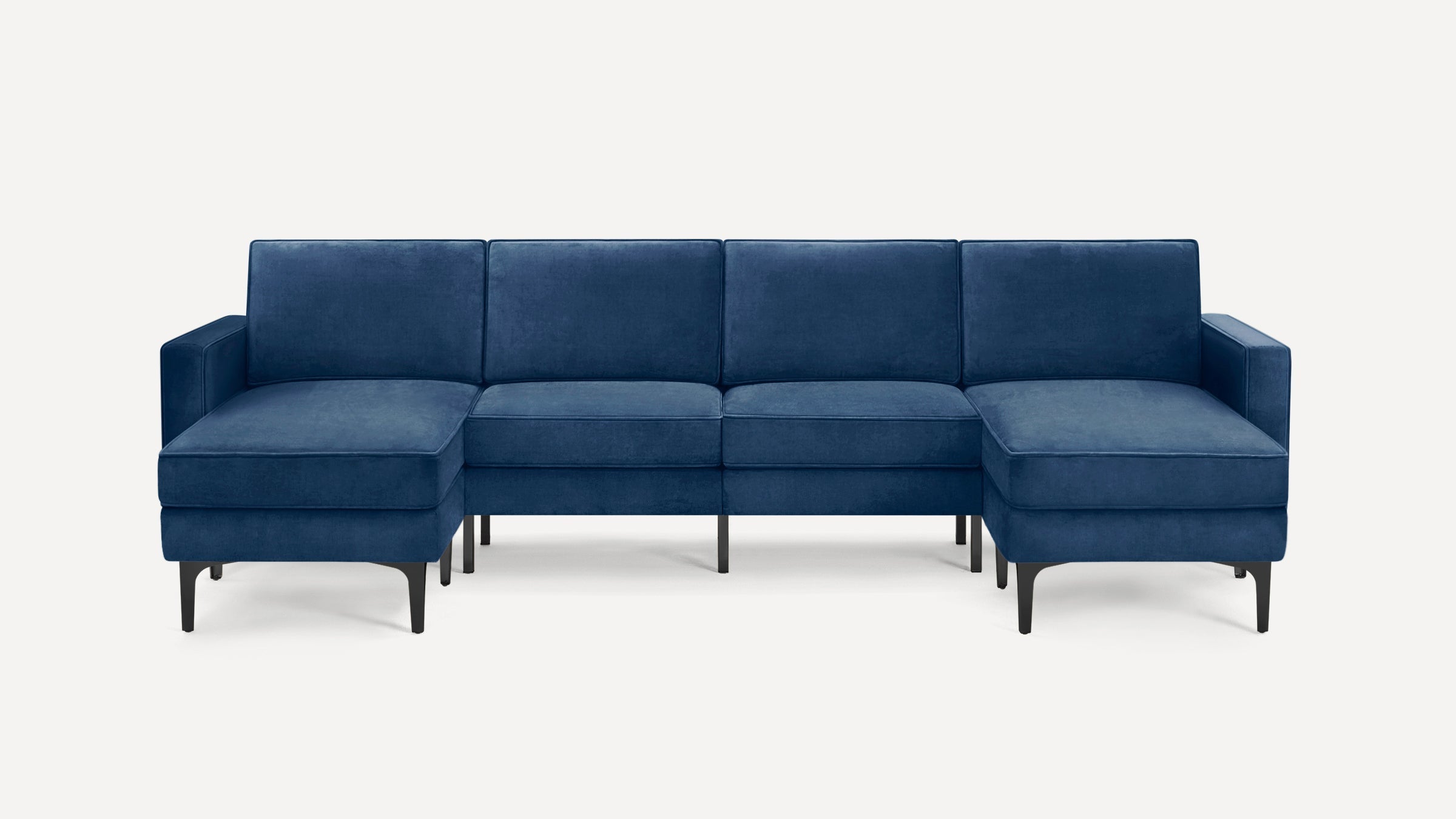 Modern sectional sofa in rich navy blue velvet fabric with sleek black legs, featuring chaise on both ends.