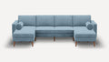 modern light blue sectional sofa with wooden legs and matching ottoman on white background