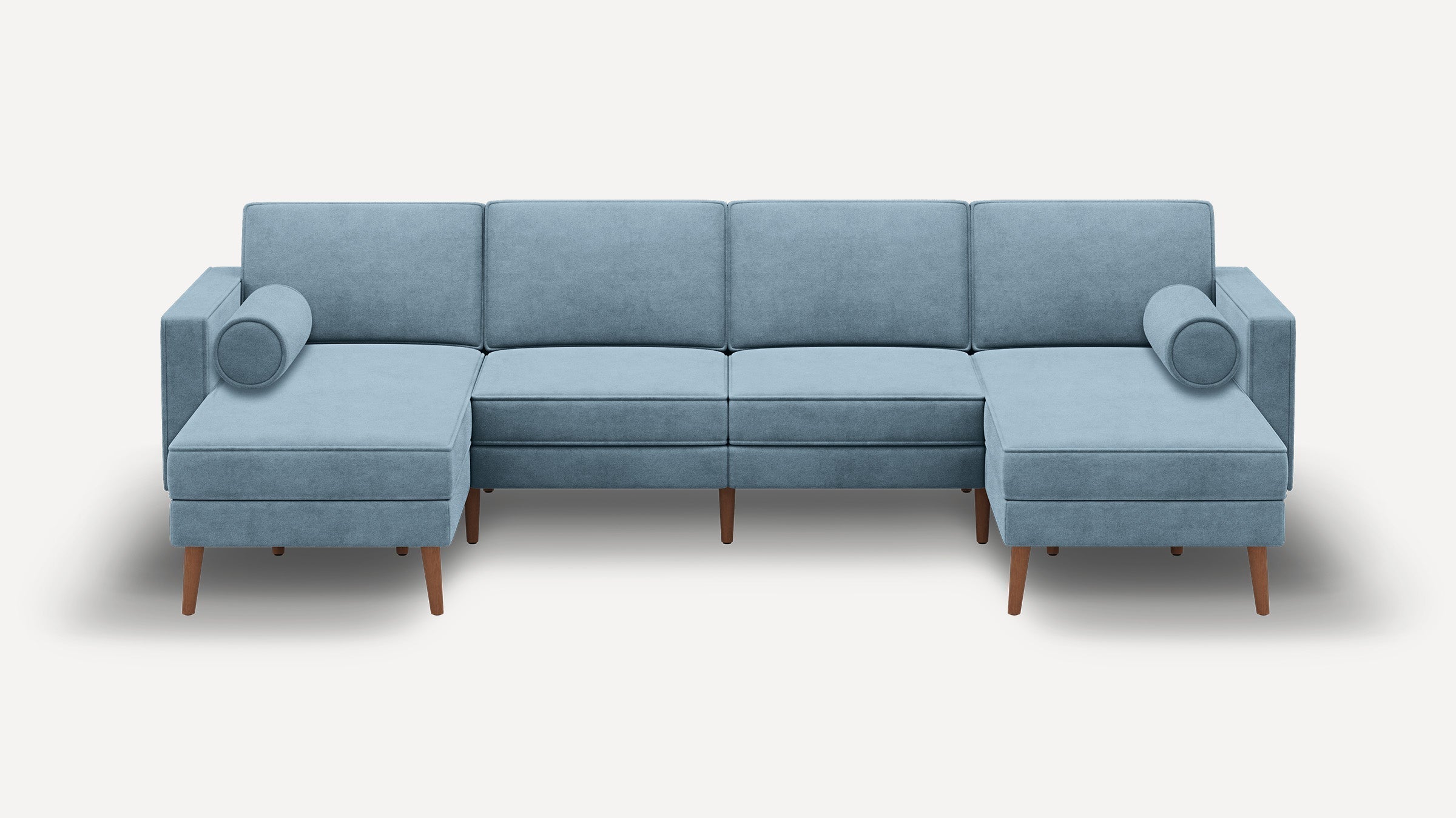 modern light blue sectional sofa with wooden legs and matching ottoman on white background