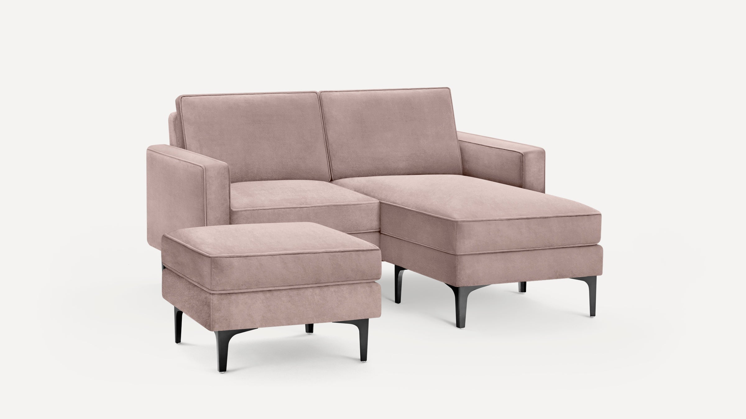 Light mauve sectional sofa with matching ottoman, clean lines, and black tapered legs, set against a white background.