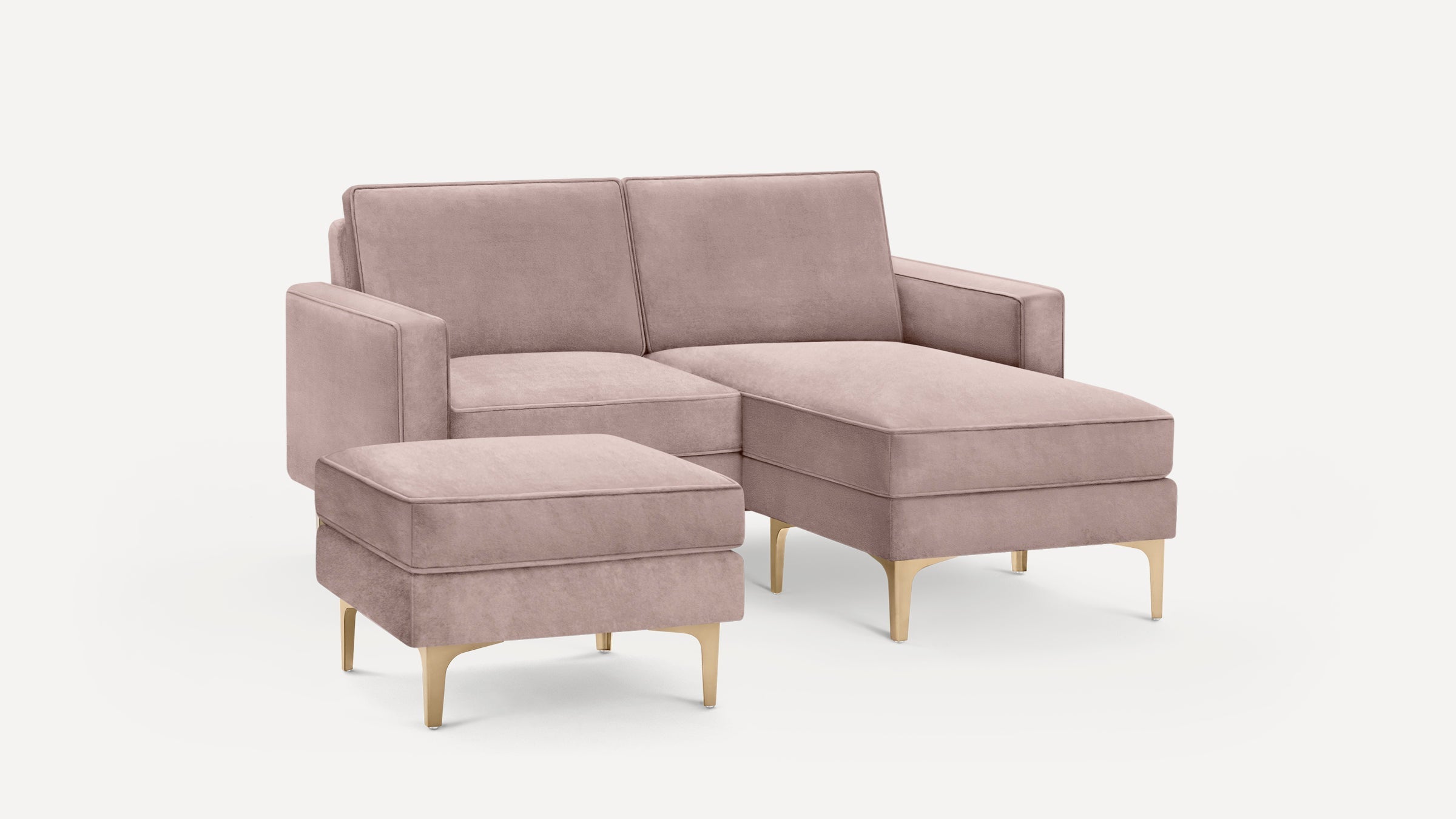 Modern dusty pink sectional sofa with matching ottoman, soft upholstery, gold metallic legs, and clean lines on a white background.