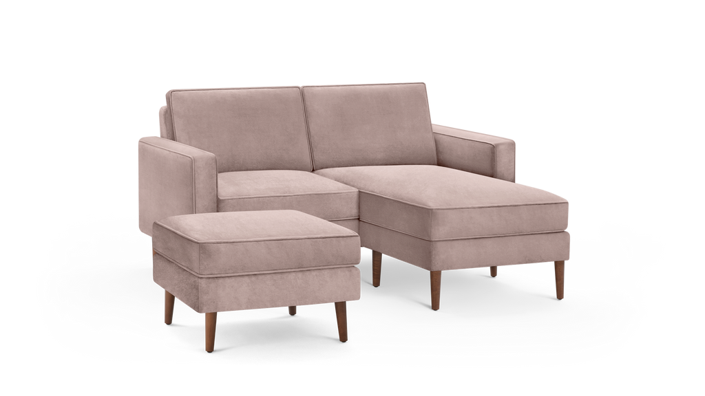 modern beige sectional sofa with matching ottoman and matching ottoman, featuring wooden legs and a sleek design