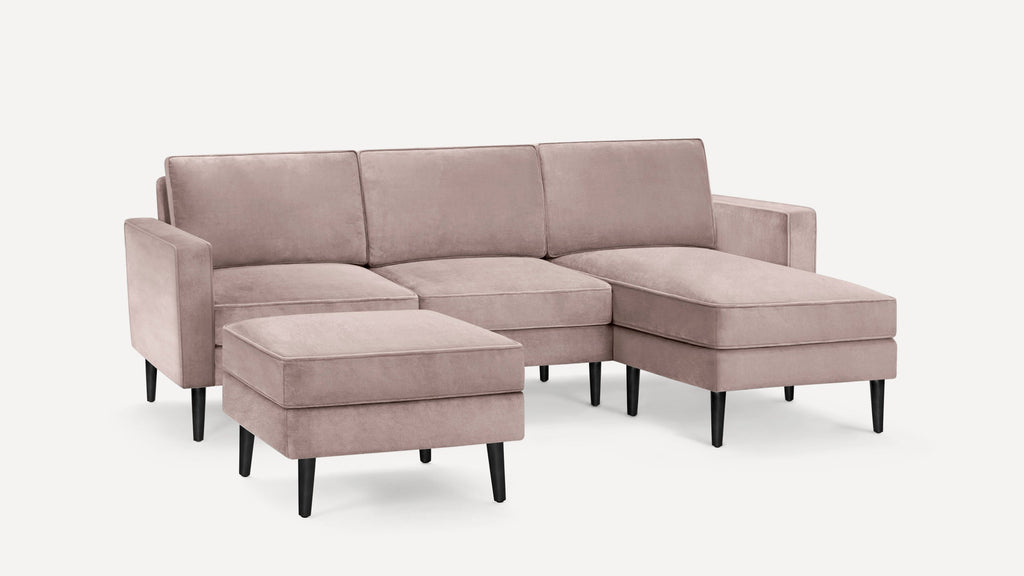 Modern dusty pink velvet sectional sofa with matching ottoman, black tapered legs, and clean-lined design.