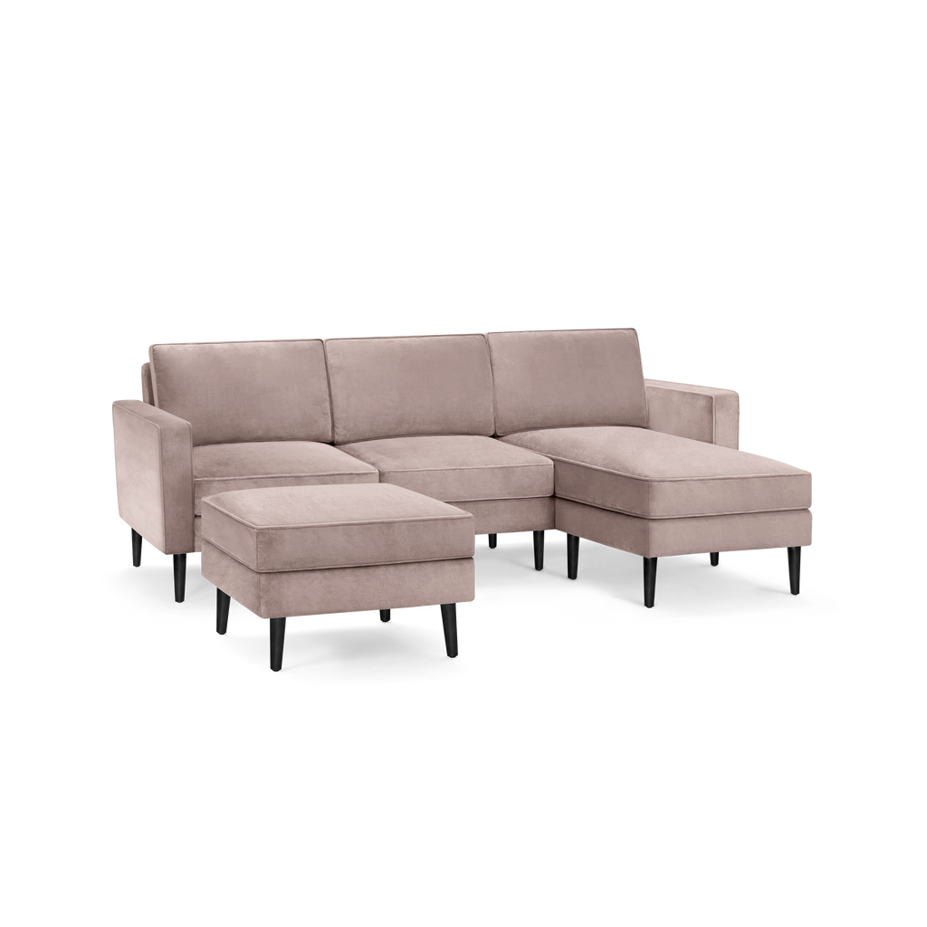 modern l - shaped sectional sofa with sleek black legs and a soft tau colored fabric upholstery, featuring a sleek, modern design