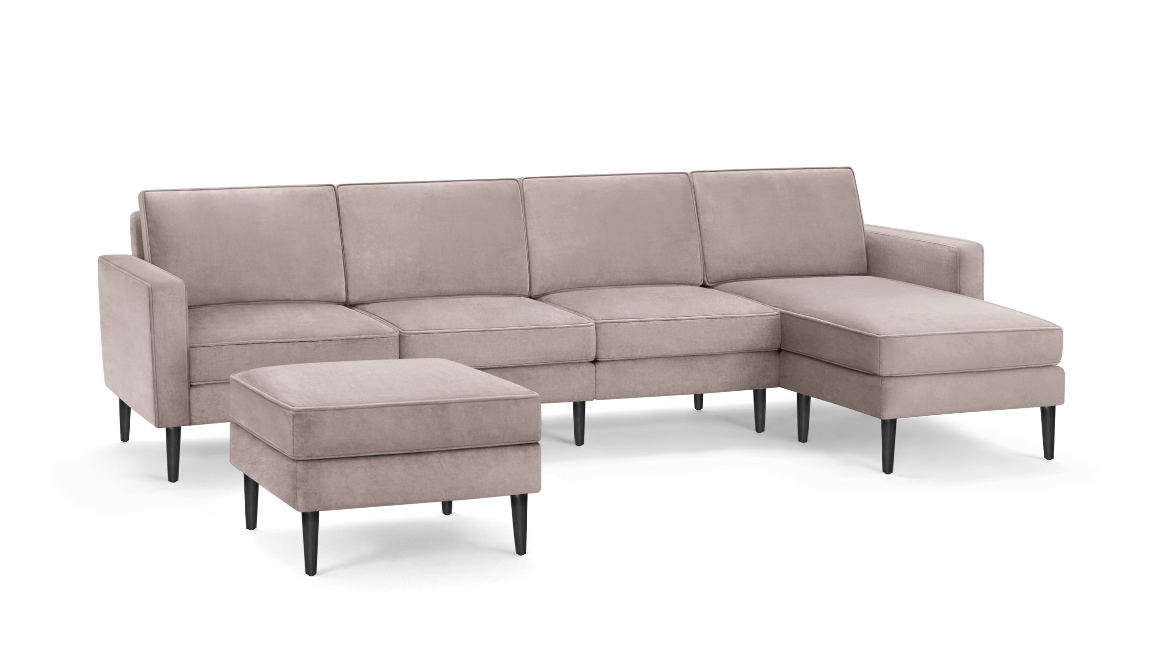 modern l - shaped sectional sofa with sleek black legs and a soft blush fabric upholstery, featuring a sleek, modern design