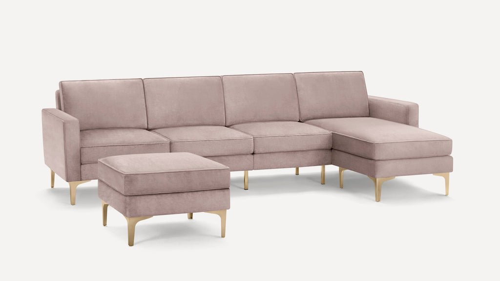 Light pink velvet sectional sofa with chaise and matching ottoman, featuring gold metal legs and clean modern lines.