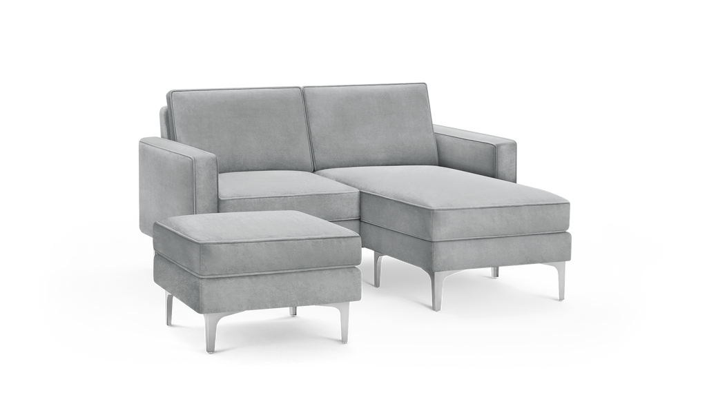 modern light gray velvet sectional sofa with matching ottoman and matching ottoman, featuring tapered legs and a sleek design