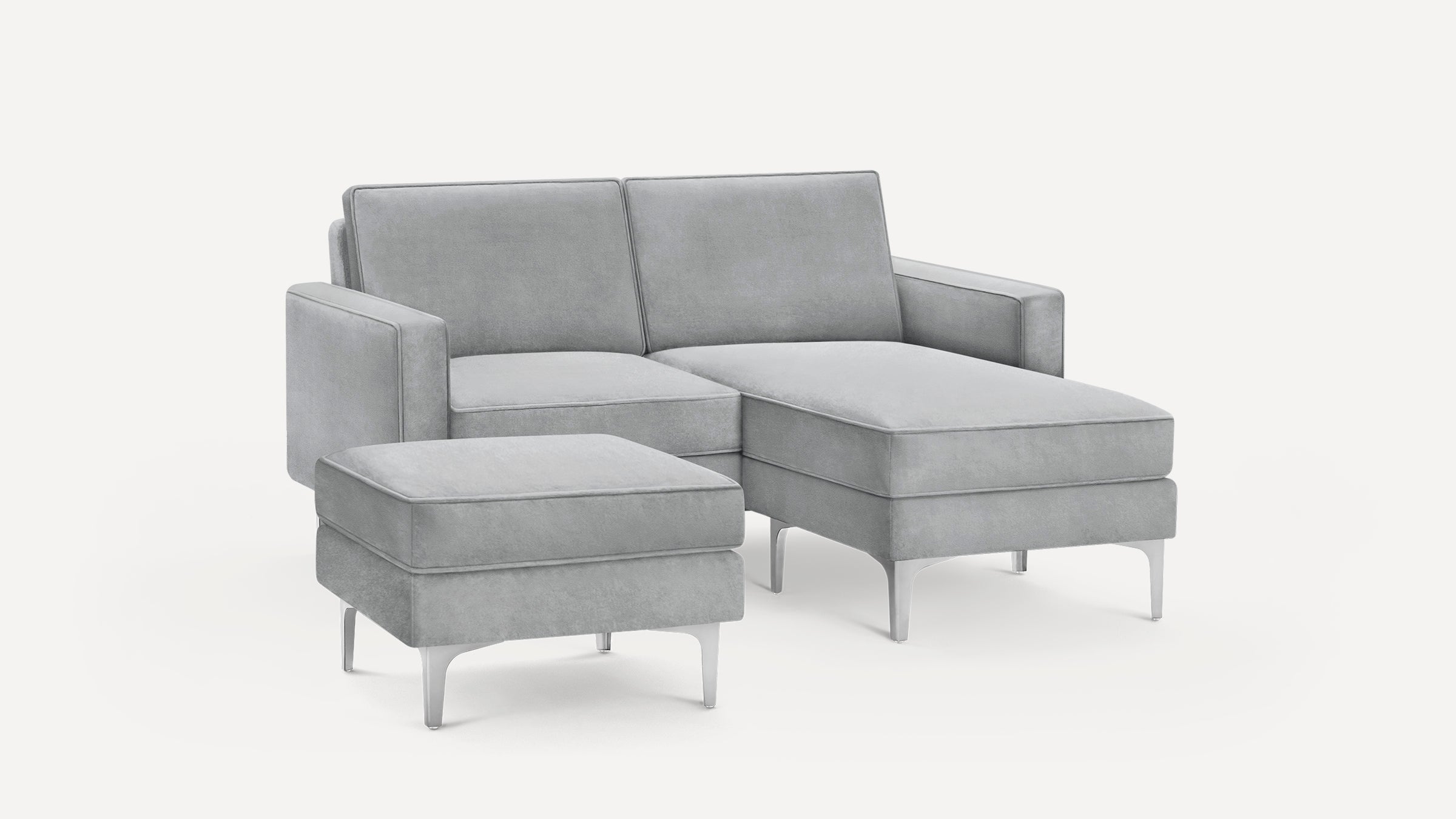 Light gray modern sectional sofa with chaise lounge and matching ottoman, featuring clean lines and metal legs.