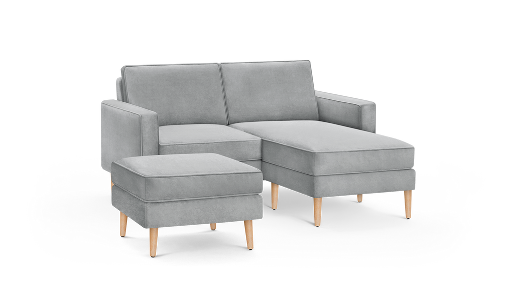 light gray modern sectional sofa with matching ottoman and wooden legs, featuring a clean, minimalist design