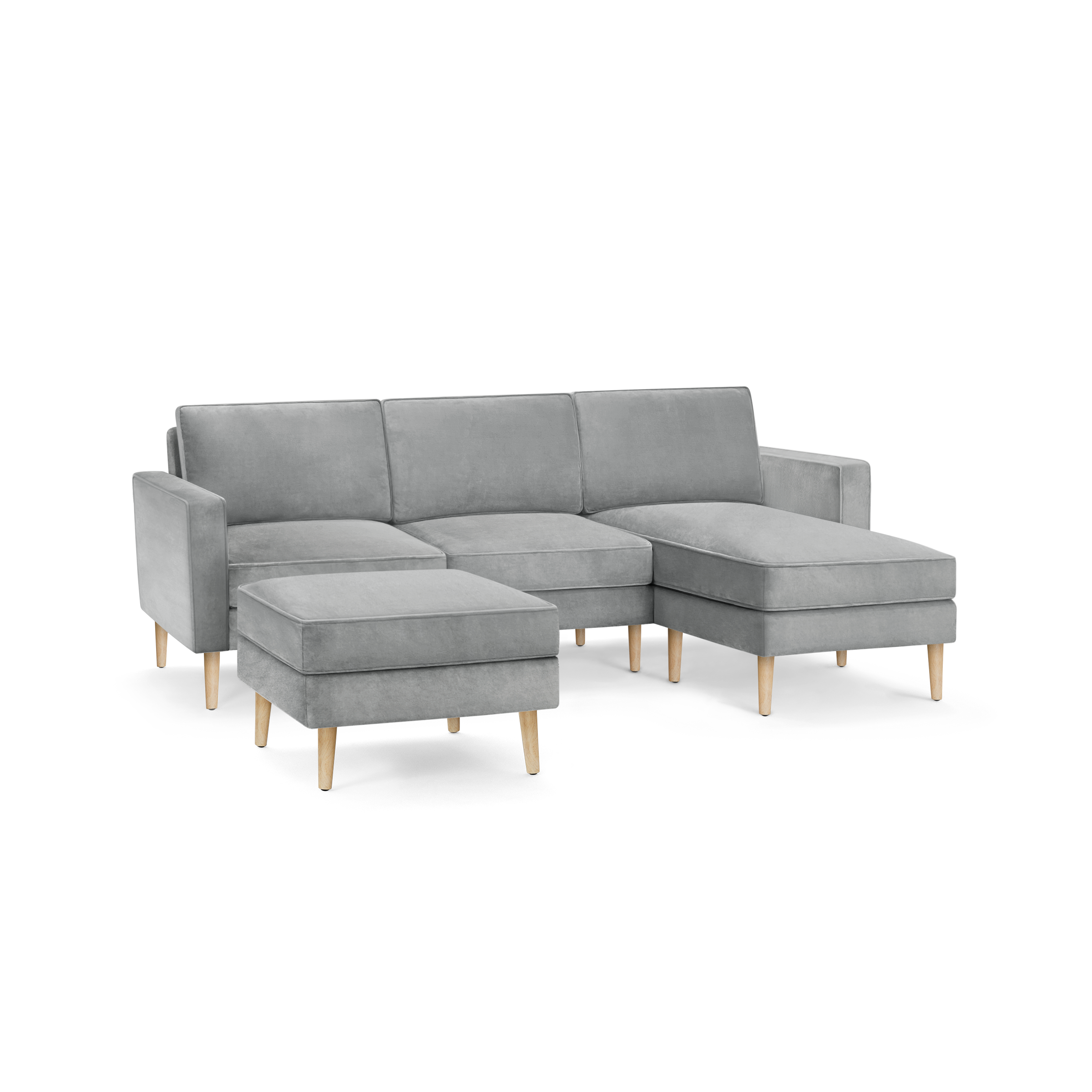 modern l - shaped sectional sofa with light gray fabric upholstery, tapered wooden legs, and matching ottoman, featuring a clean, modern