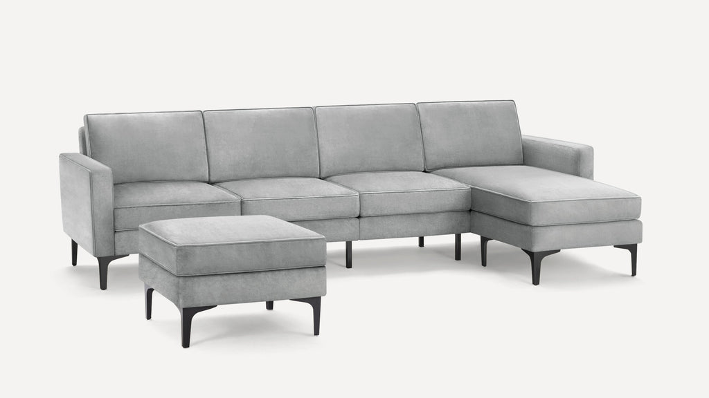Light gray sectional sofa with chaise and matching ottoman, featuring sleek black legs and modern clean lines.