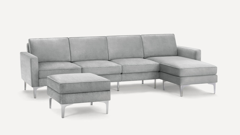Modern light gray velvet sectional sofa with chaise and matching ottoman, featuring sleek metal legs and clean lines.