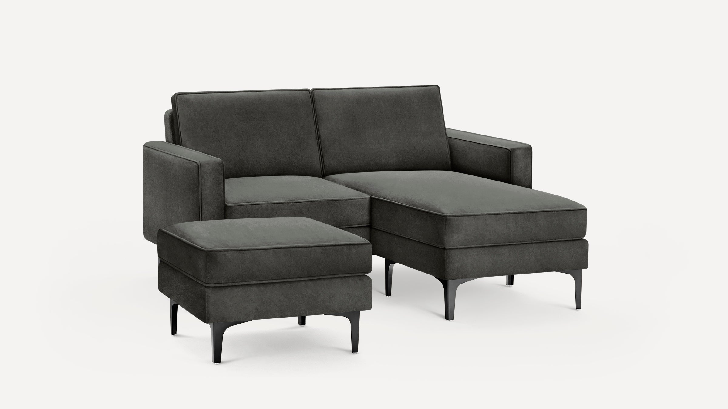 Modern dark gray sectional sofa with chaise lounge and matching ottoman, featuring clean lines and black legs.