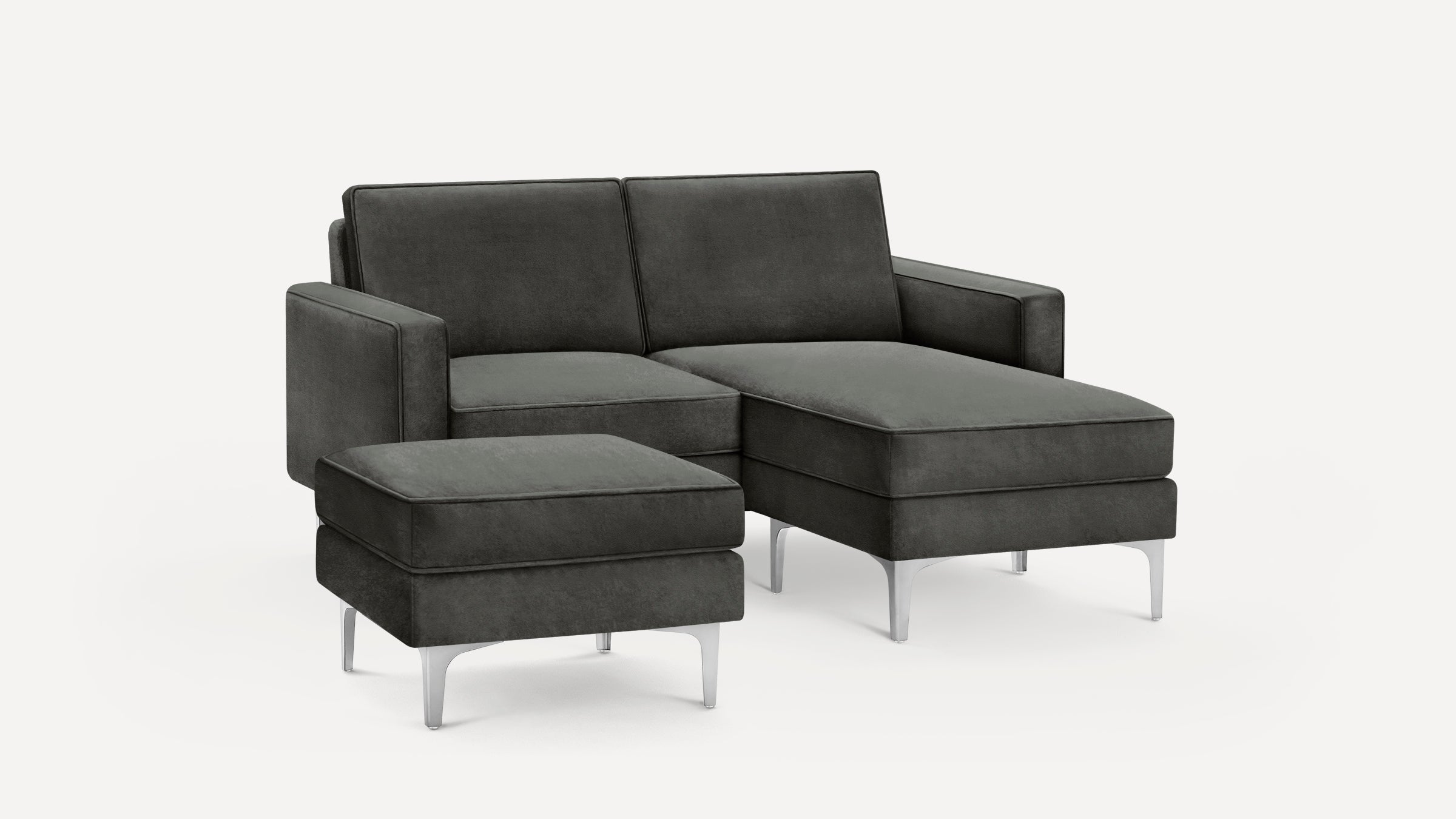 Dark gray upholstered sectional sofa with matching ottoman, featuring clean lines and metal legs, on a white background.