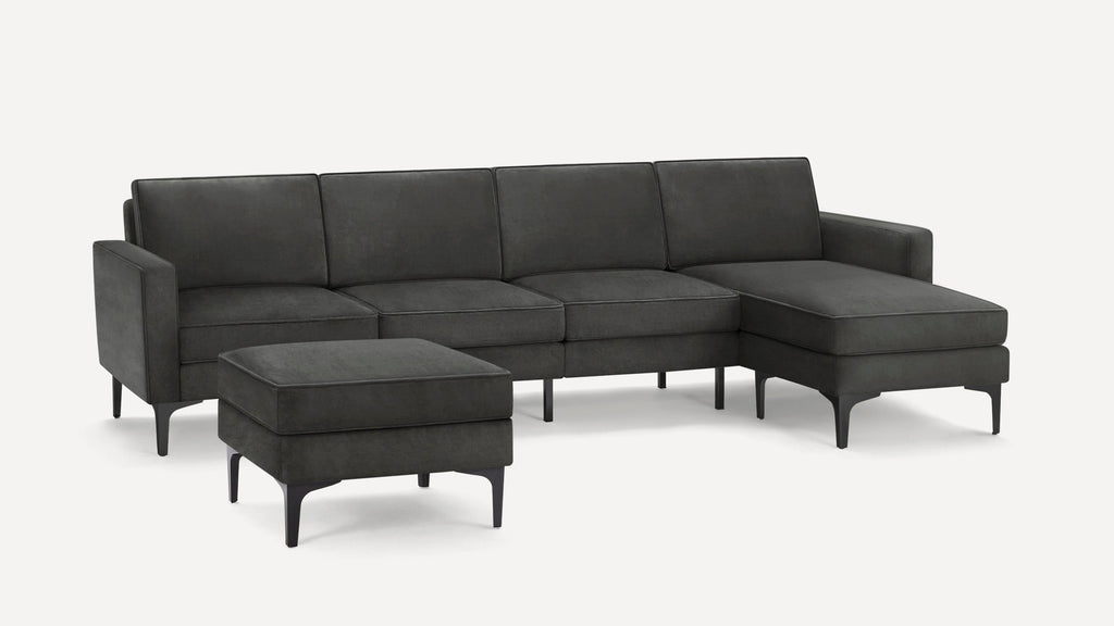 Dark gray modern sectional sofa with chaise lounge and matching ottoman, featuring slim black legs and clean lines.
