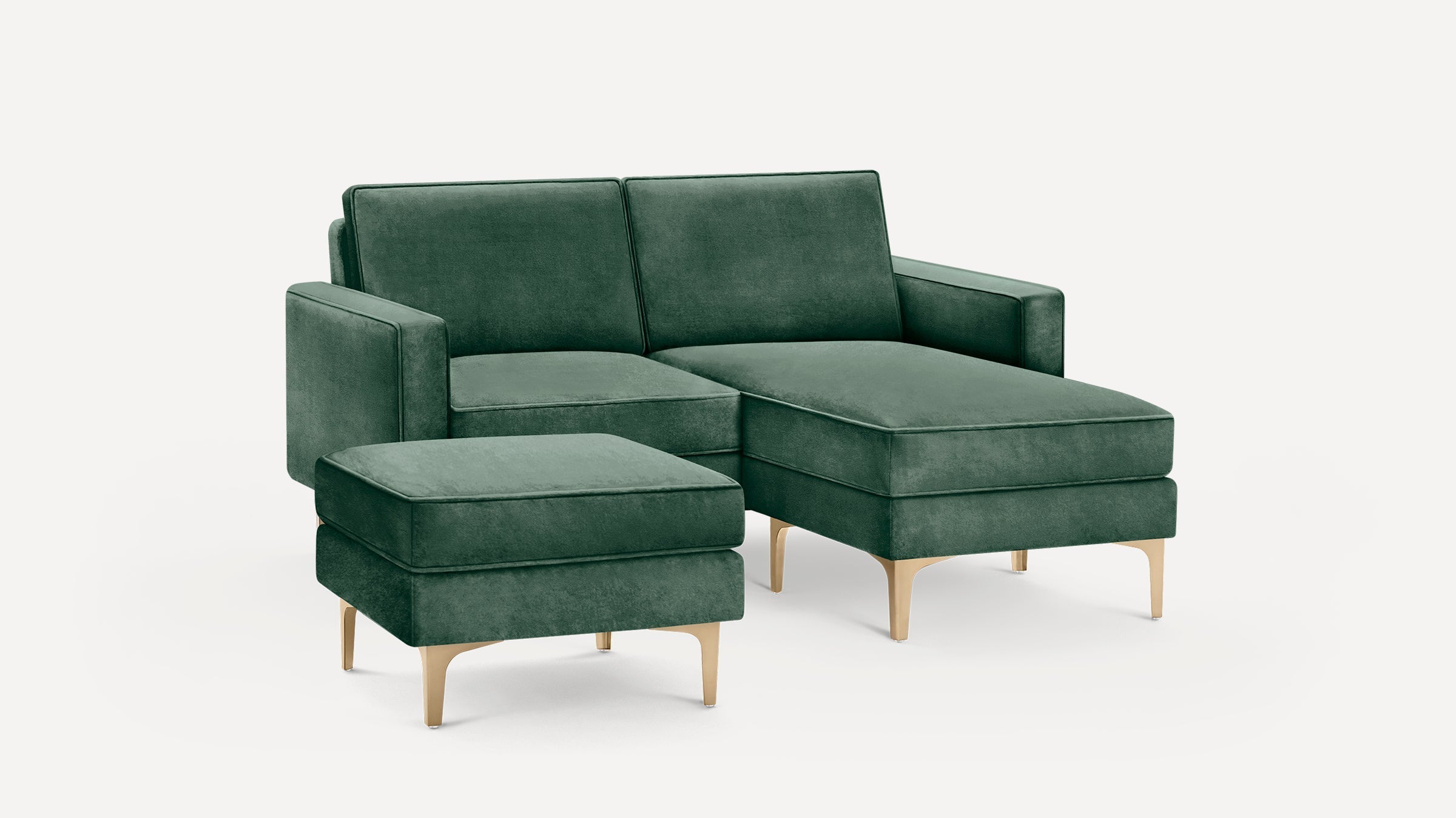 Green velvet sectional sofa with matching ottoman, featuring sleek gold metal legs and clean modern design.