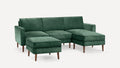 Green velvet sectional sofa with matching ottoman, wooden tapered legs, and clean, modern lines.