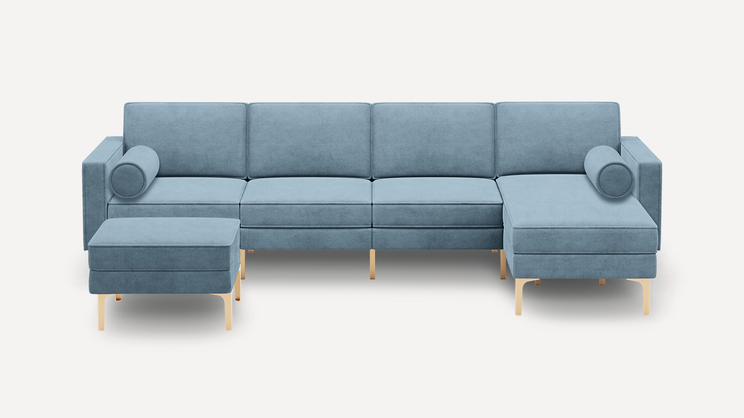 Modern light blue velvet sectional sofa with gold metal legs, featuring a chaise lounge and two cylindrical pillows.