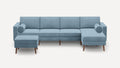 modern light blue sectional sofa with wooden legs and matching ottoman on white background