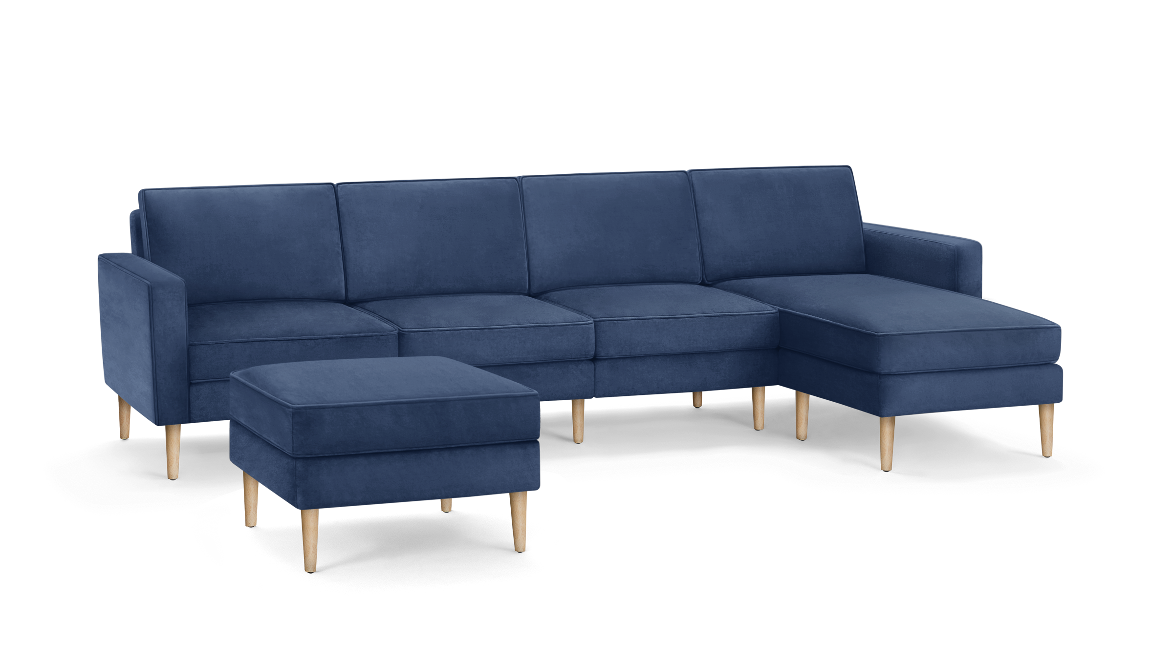 modern navy blue velvet sectional sofa with wooden legs and matching ottoman, featuring a clean, minimal design