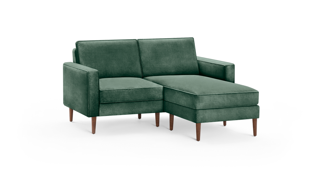 modern green velvet sectional sofa with wooden legs and matching ottoman, featuring a deep - green upholstery, featuring a matching ottoman
