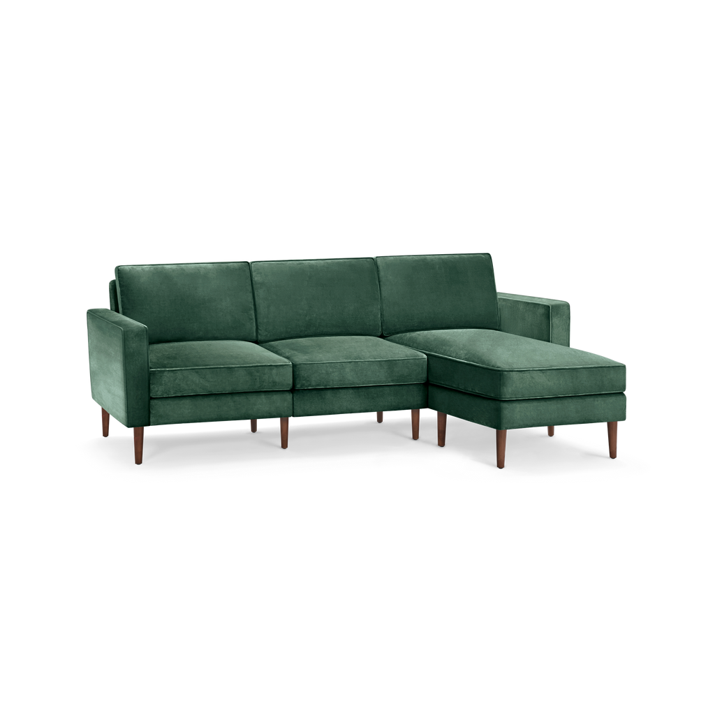 modern l - shaped sectional sofa with green velvet upholstery, tapered wooden legs, and clean lines on the back, designed for