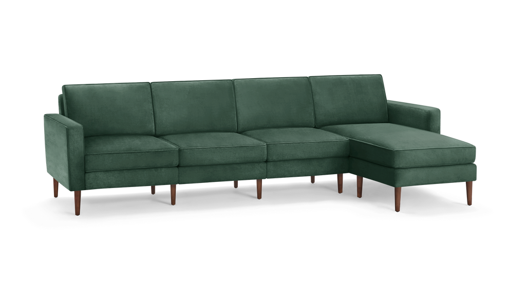 modern green velvet sectional sofa with wooden legs and matching ottoman, featuring a clean, minimalist design