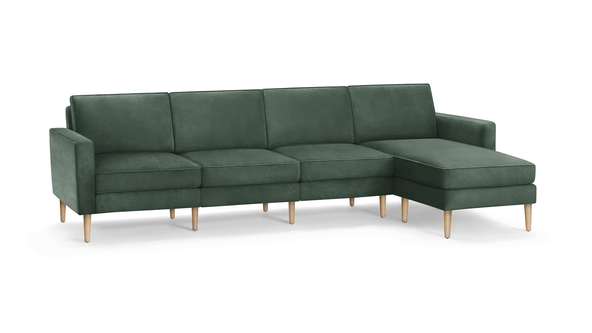 modern green velvet sectional sofa with wooden legs and matching ottoman, featuring a clean, minimal design