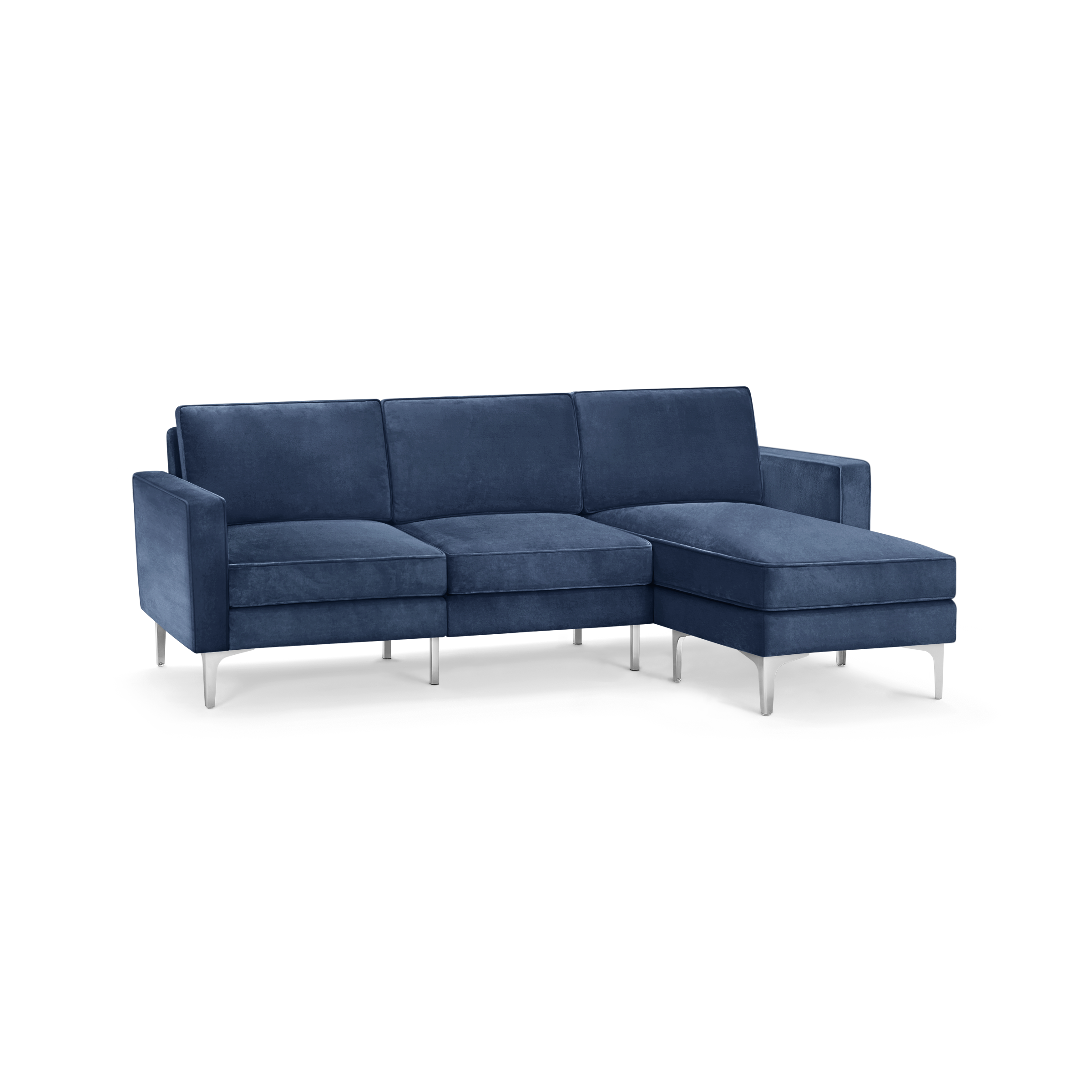 modern blue velvet sectional sofa with clean lines and clean lines, featuring a chaise lounge and matching ottoman, on a black background