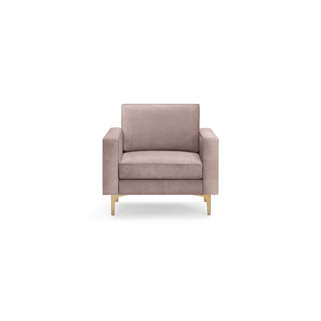 modern light pink velvet armchair with wooden legs and a sleek backrest, featuring a rounded cushion and a sleek backrest
