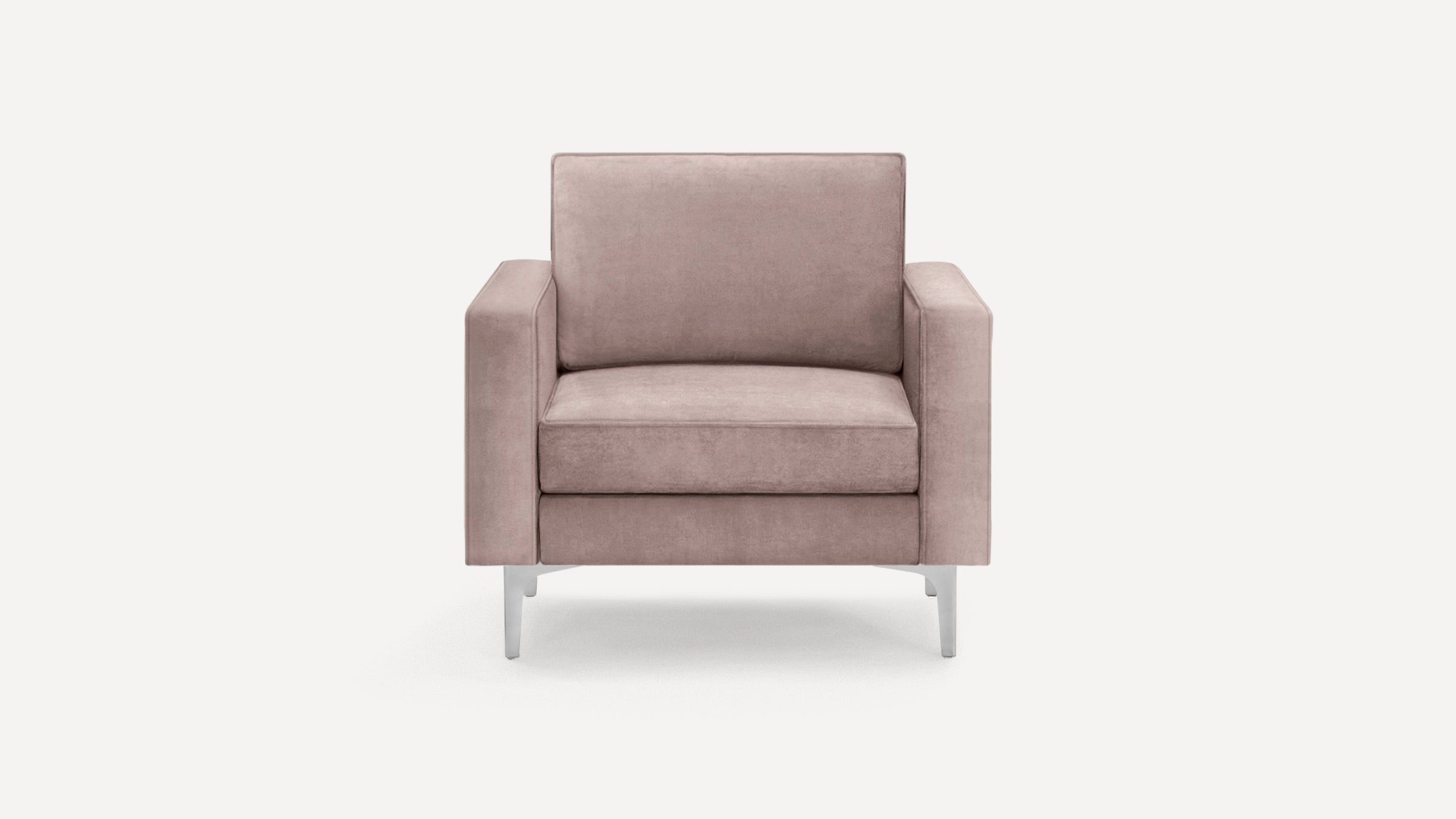 Modern dusty pink velvet armchair with boxy arms and sleek silver metal legs, shown on plain white background.