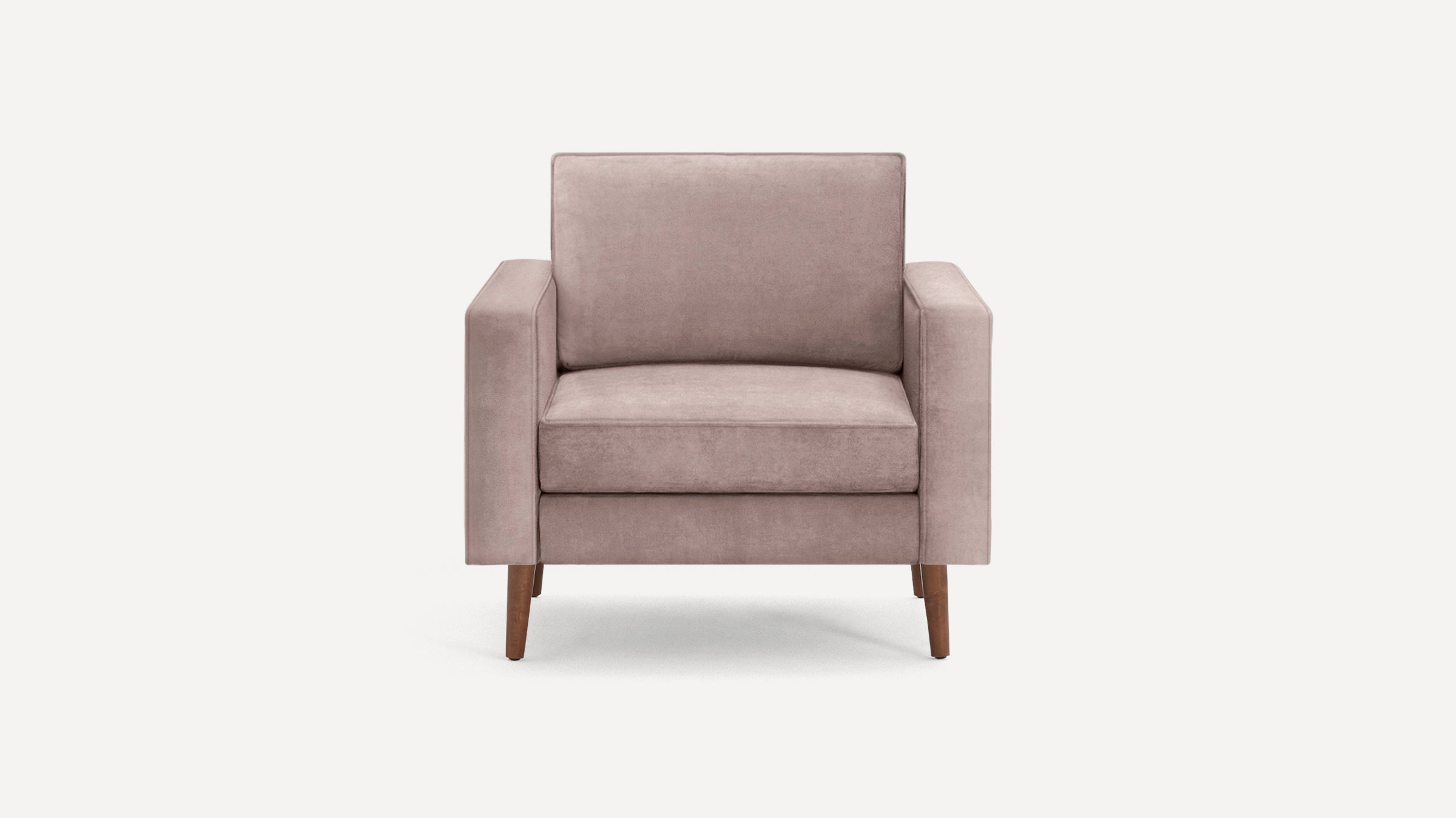 Front view of a modern blush pink upholstered armchair with wooden legs on a plain white background.