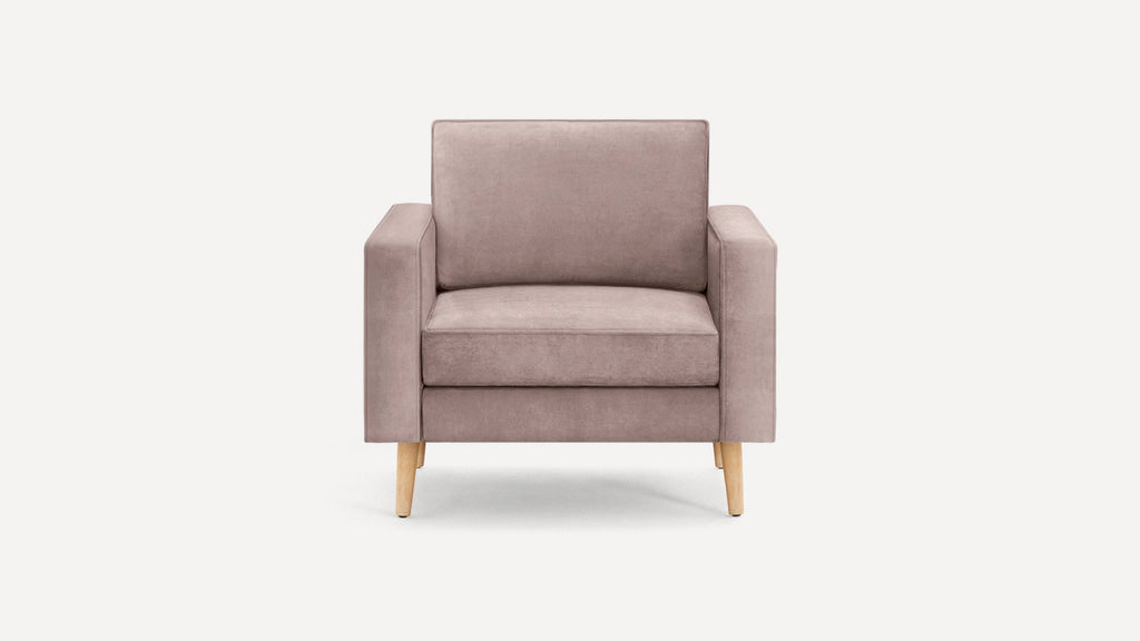 Front view of a modern single-seater armchair with light pink upholstery and light wooden legs on a white background.
