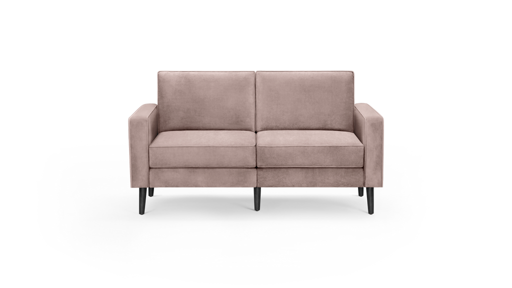 modern light pink velvet loveseat with black metal legs and sleek design on a black background