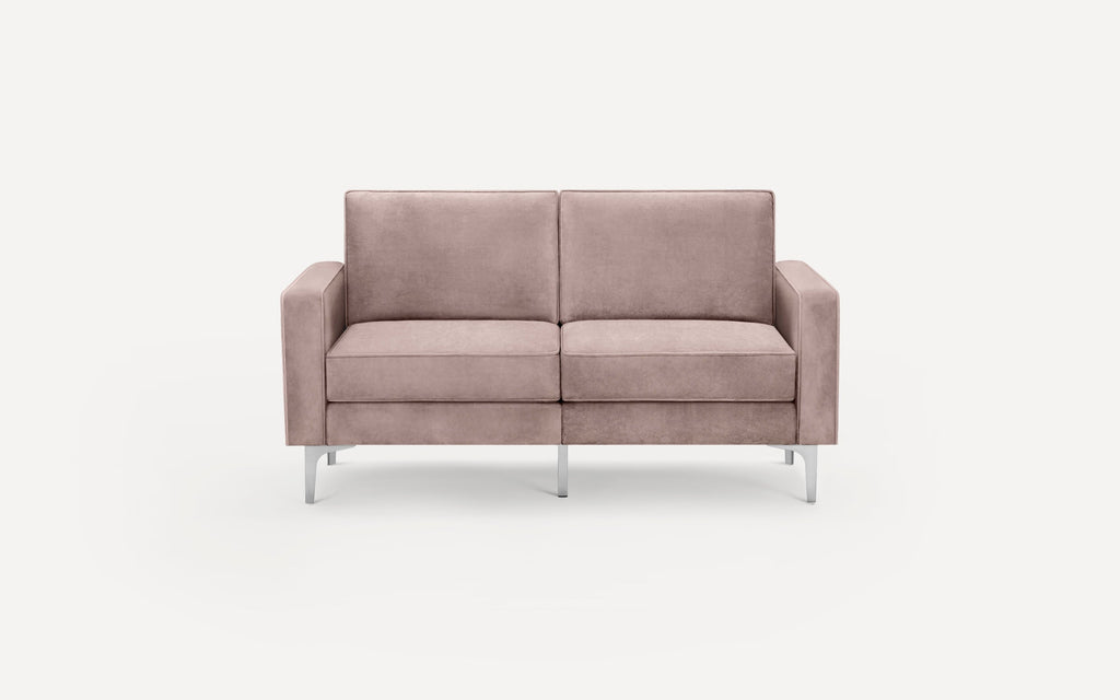 Modern two-seater sofa in muted pink fabric with straight armrests and slim, silver metal legs on a white background.