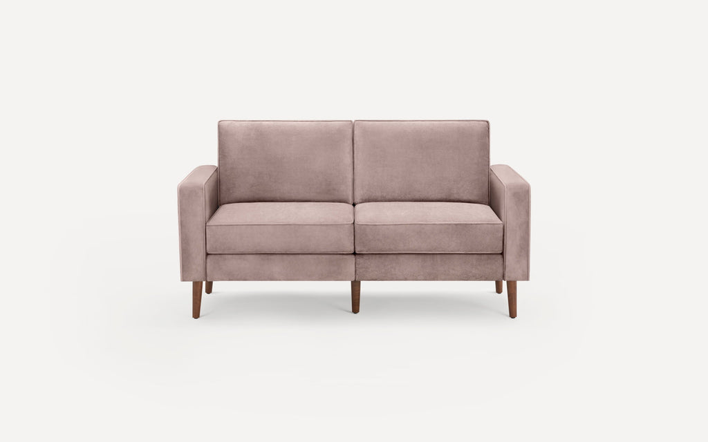 A modern two-seater sofa in soft mauve fabric with straight arms and tapered wooden legs on a white background.
