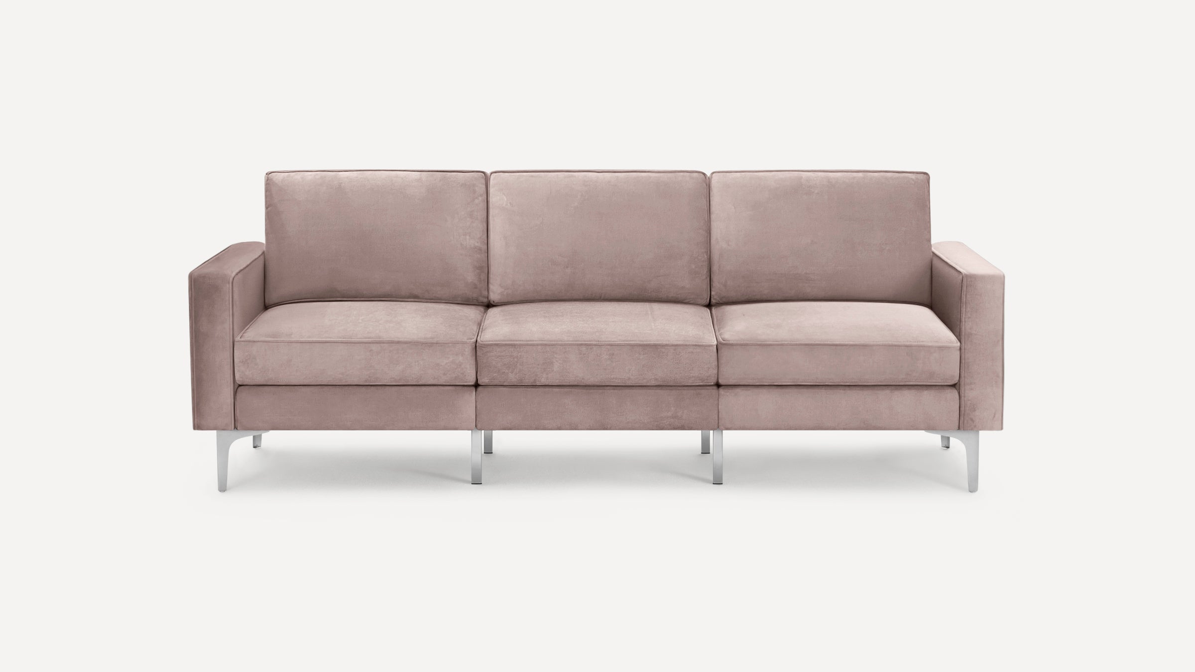 Three-seater modern sofa with soft dusty pink upholstery and sleek silver metal legs on white background.