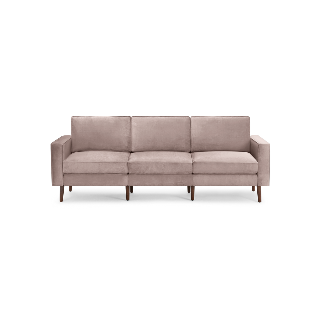 modern light pink velvet sofa with wooden legs and clean lines on the back, featuring a deep cushioned design and clean lines on the back